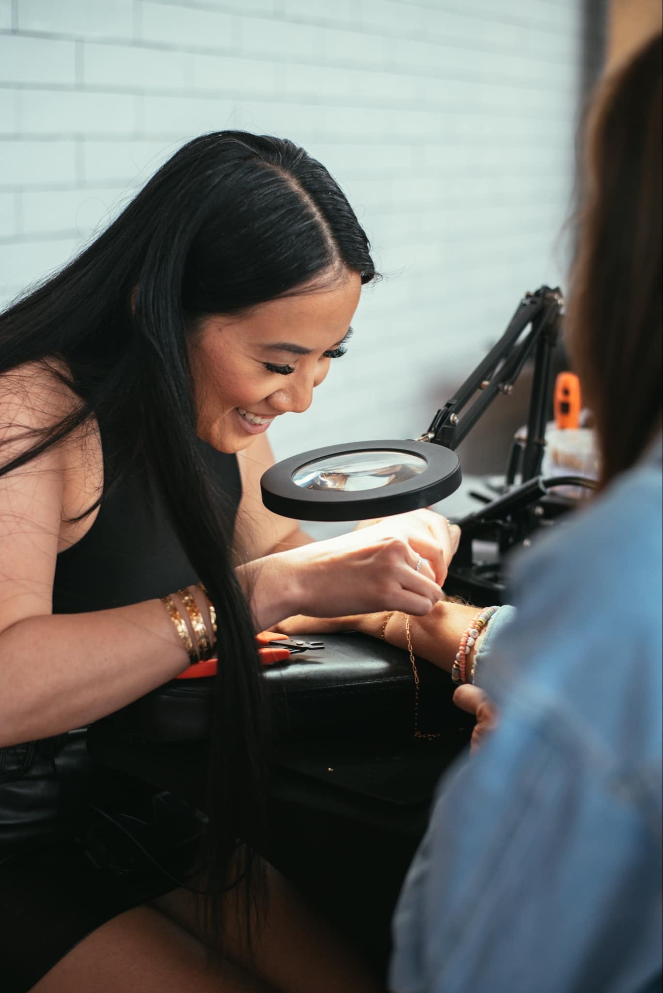 women welding bracelet during pop up event